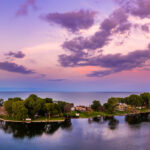 Lake Erie during a purple sunset, with vibrant hues reflecting on the calm waters.