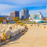 Milwaukee, Wisconsin boardwalk, featuring scenic views of the waterfront with the city skyline in the background.