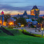 Fairmont Le Chateau Frontenac, a grand castle-like hotel with elegant architecture, set against a vibrant cityscape.