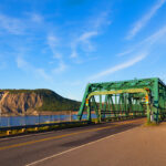 A view of the Canso Causeway, connecting Cape Breton Island to mainland Nova Scotia, surrounded by blue waters.