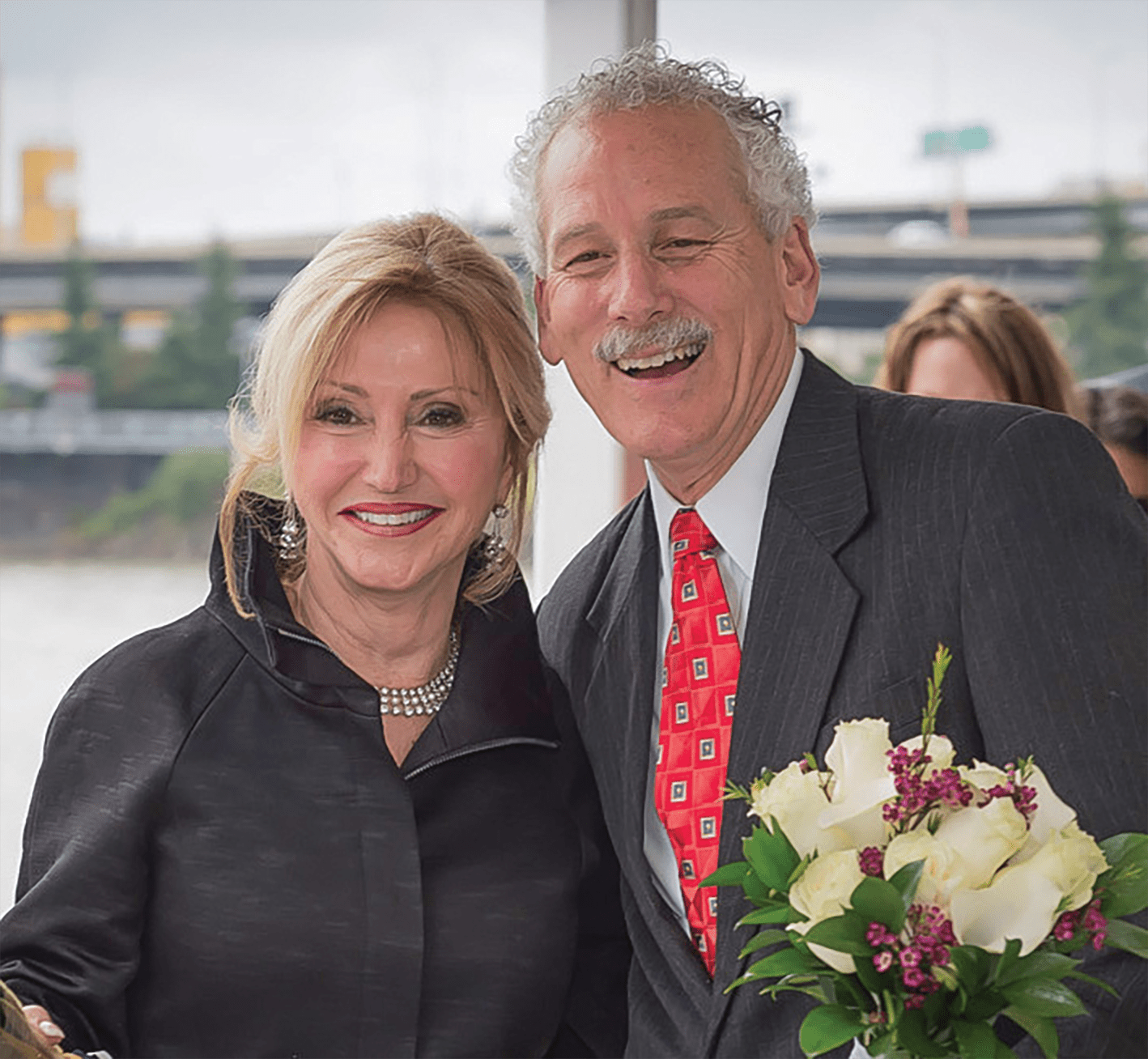 John Waggoner, CEO of Victory Cruise Lines, smiling with his wife at his side.