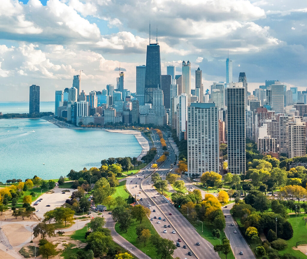 A stunning view of Chicago city skyline with modern skyscrapers reflecting in the waters.