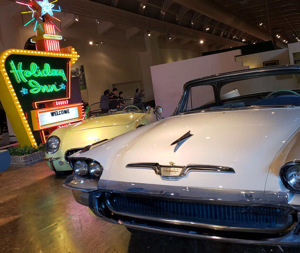 A picture of the Henry Ford Museum, featuring a display of classic cars.