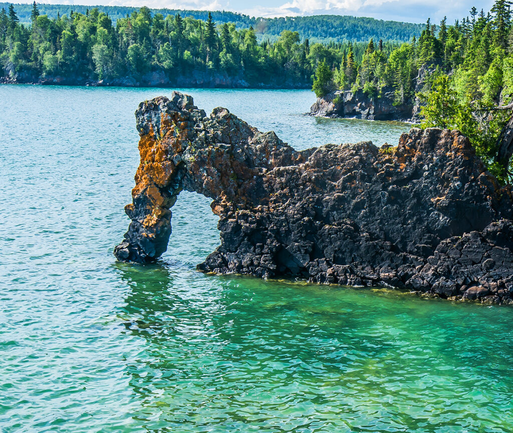 A breathtaking view from Thunder Bay Lookout, showcasing a panoramic vista of rugged cliffs, dense forests.